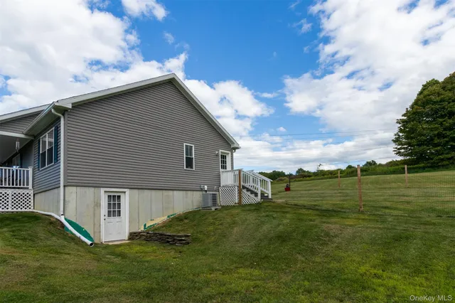 a view of a lush green forest with trees in the background