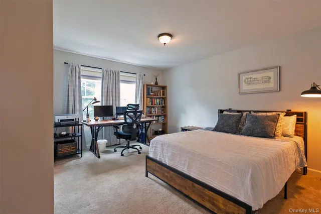 a bed room with a bed and a chair