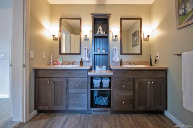 a bathroom with a double vanity sink and a mirror