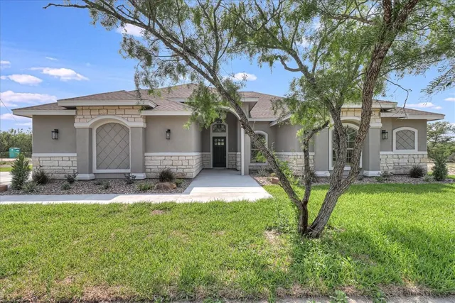 a front view of a house with a yard and garage