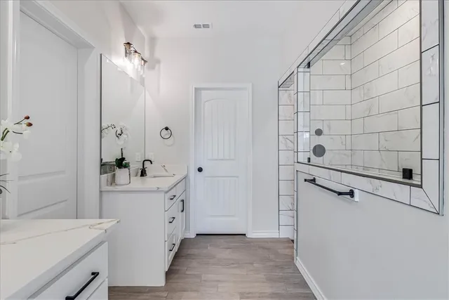 a view of a bathroom with a sink and mirror