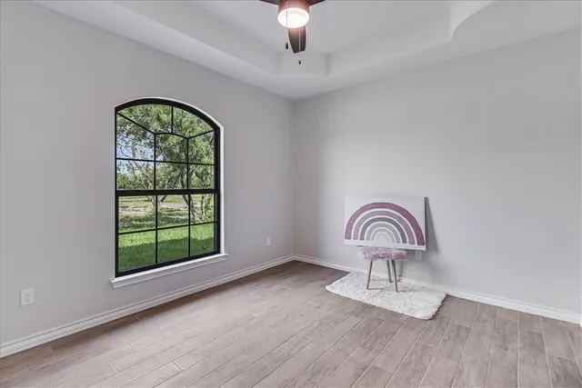 a view of wooden floor chandelier and entryway