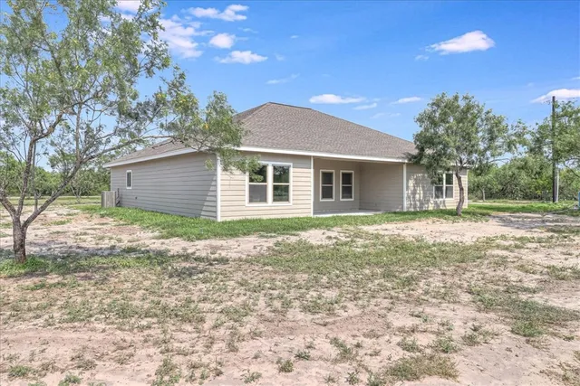 a backyard of a house with large trees