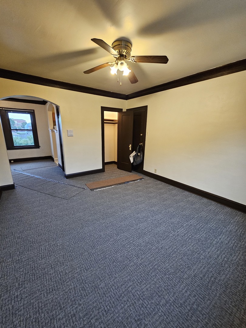 121 West 80th Street, Unit 2E Chicago, IL 60620 - Photo 2 of 7 a view of a livingroom with a ceiling fan and window