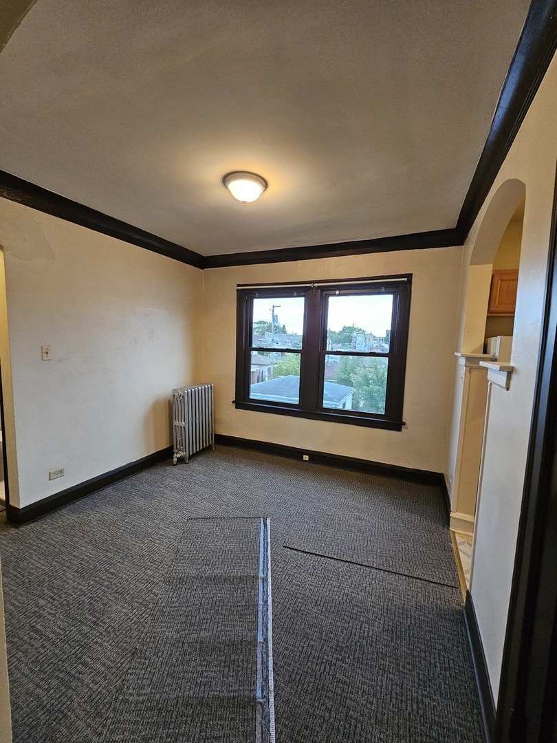121 West 80th Street, Unit 2E Chicago, IL 60620 - Photo 5 of 7 a view of an empty room with a window