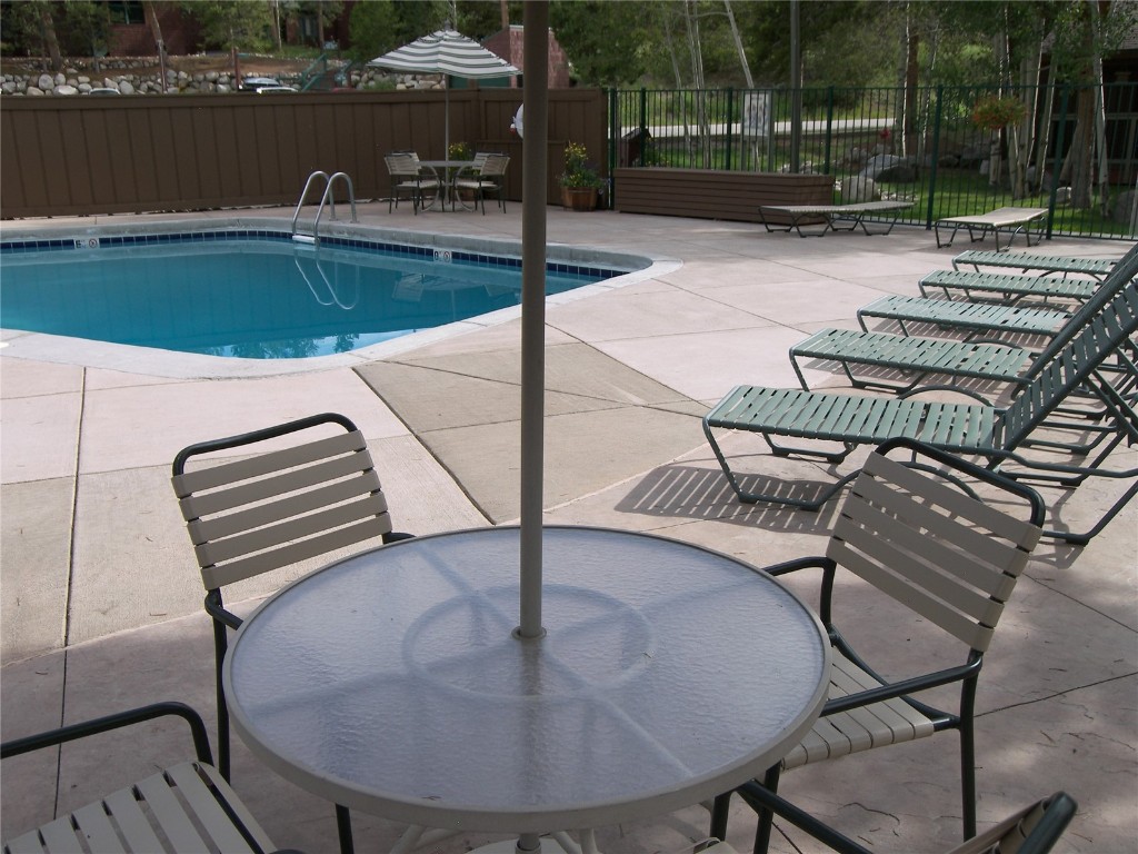 373 Wild Irishman Road, Unit 1071 Keystone, CO 80435 - Photo 16 of 22 Community pool featuring outdoor dining space and a patio