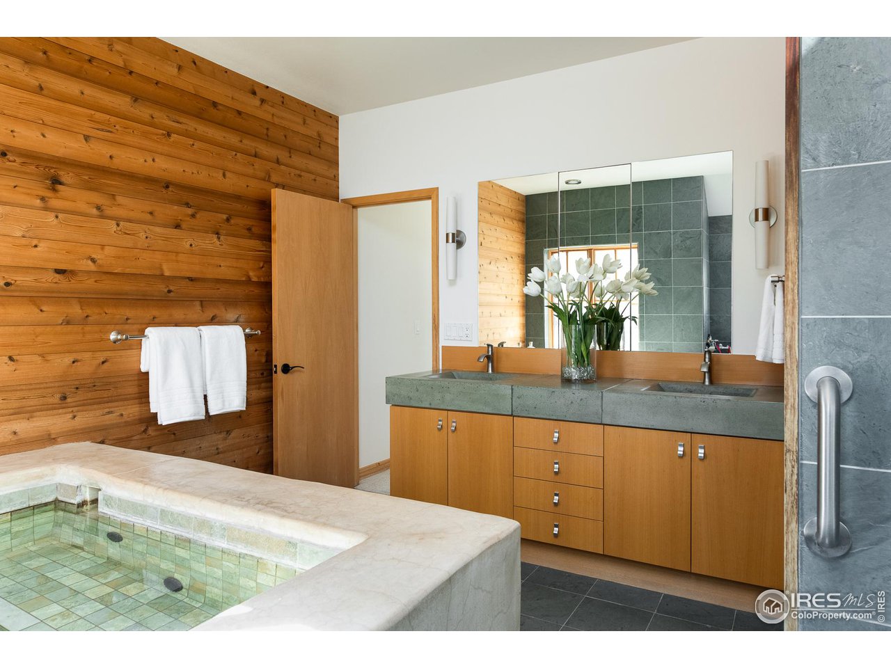 2358 Sunshine Canyon Drive Boulder, CO 80302 - Photo 12 of 36 a bathroom with a sink a mirror and a shower