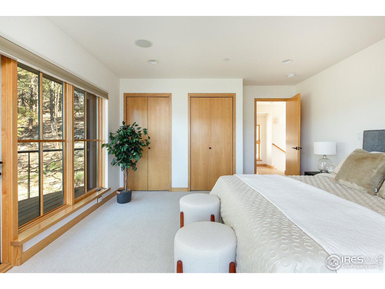 2358 Sunshine Canyon Drive Boulder, CO 80302 - Photo 20 of 36 a bedroom with a large bed and a large window