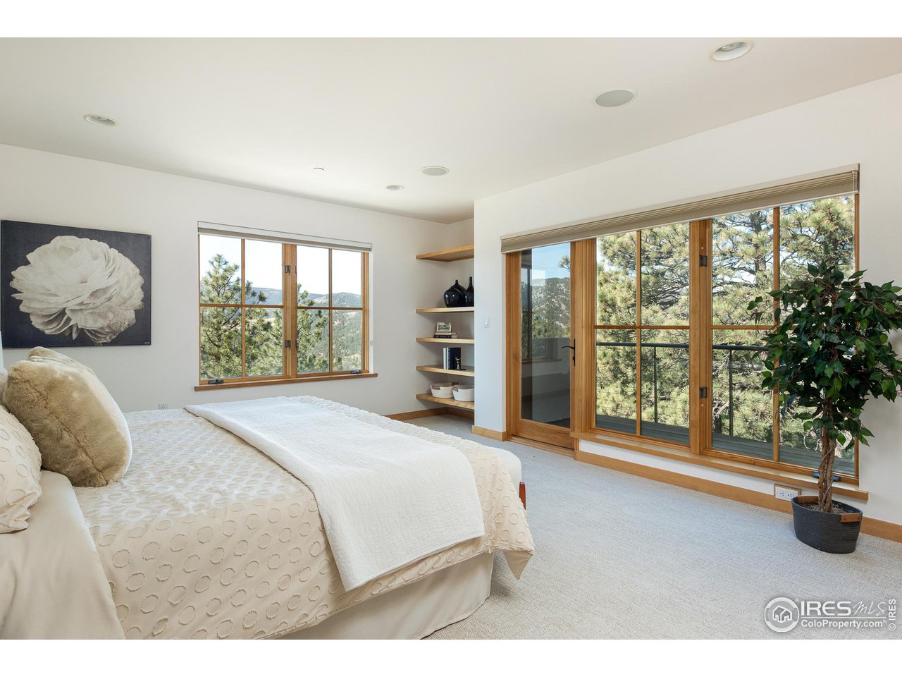 2358 Sunshine Canyon Drive Boulder, CO 80302 - Photo 21 of 36 a bedroom with a large bed and a large window