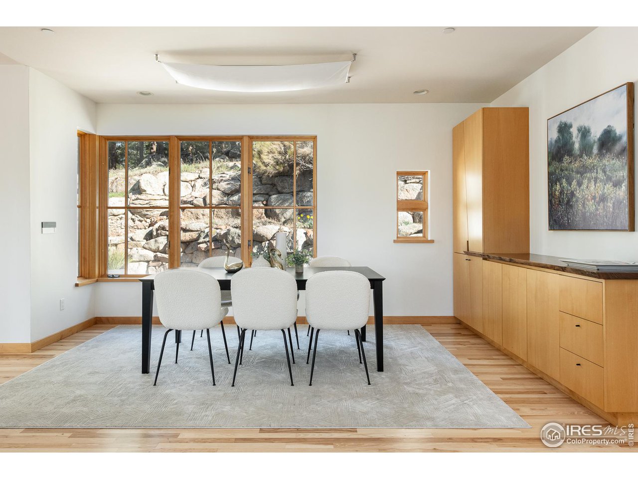 2358 Sunshine Canyon Drive Boulder, CO 80302 - Photo 6 of 36 a dining room with furniture a rug and a painting