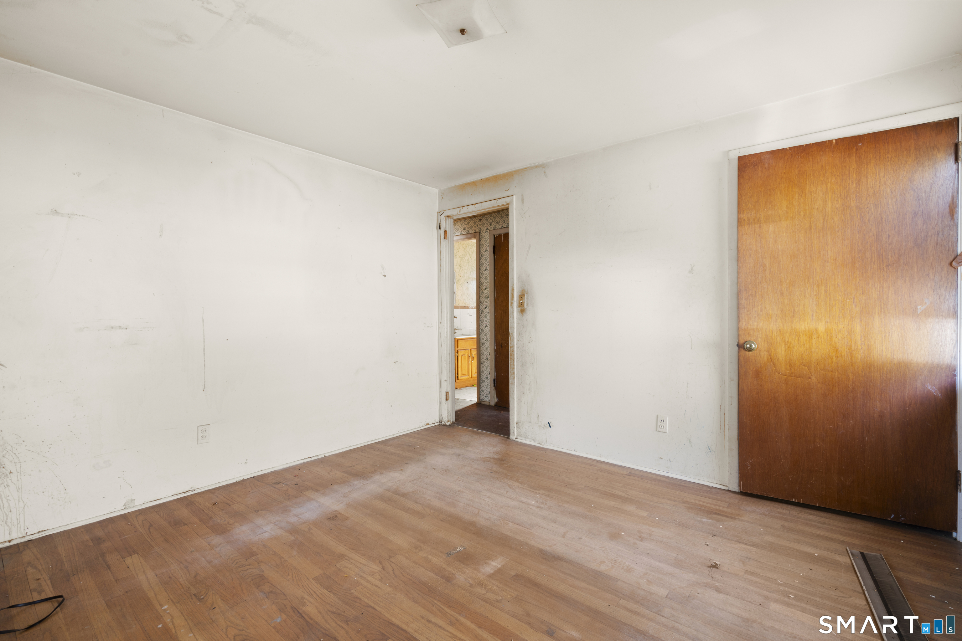 75 Brookside Avenue Bridgeport, CT 06606 - Photo 14 of 24 a view of an empty room with wooden floor and a window