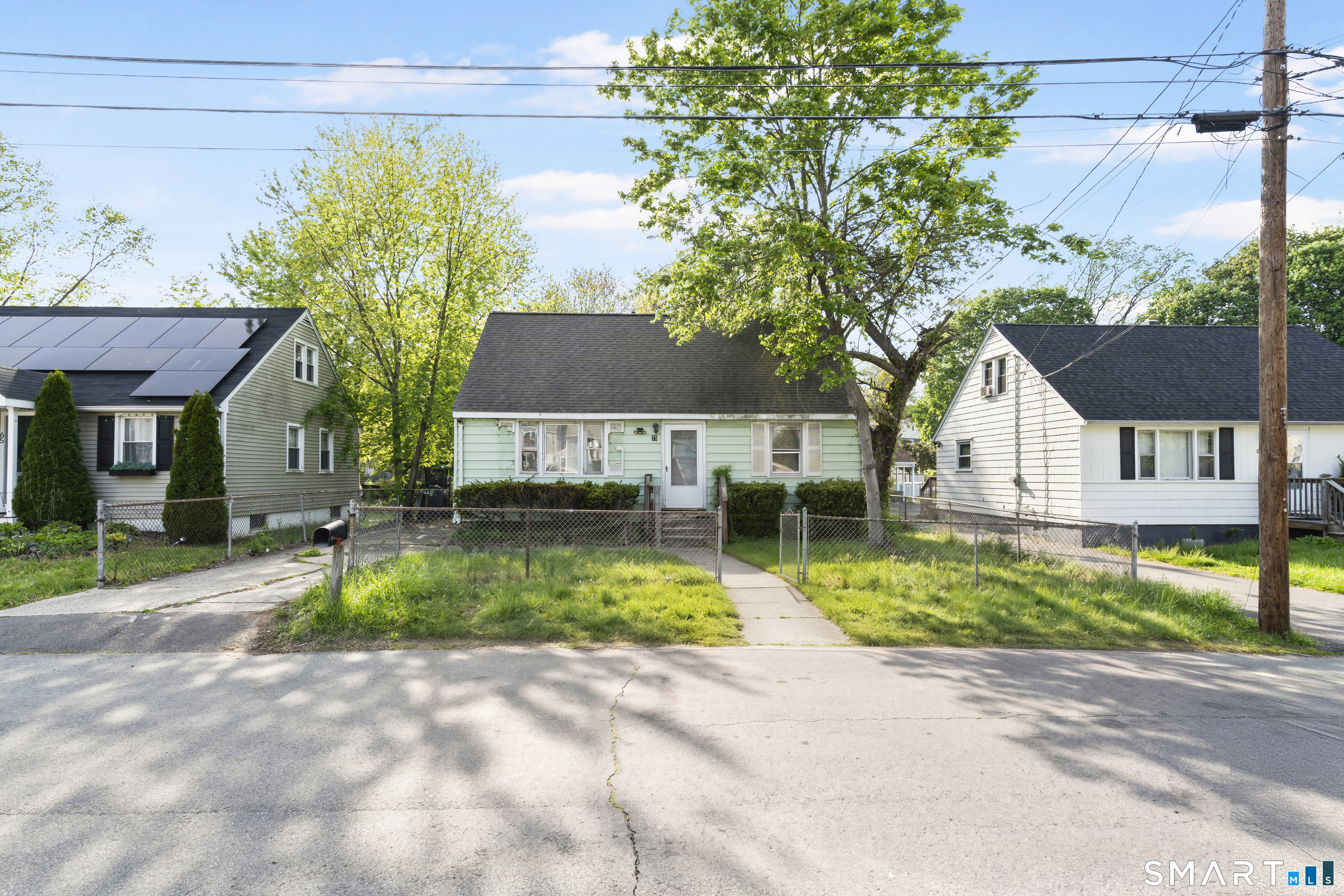 75 Brookside Avenue Bridgeport, CT 06606 - Photo 2 of 24 a view of a house with a small yard and large tree