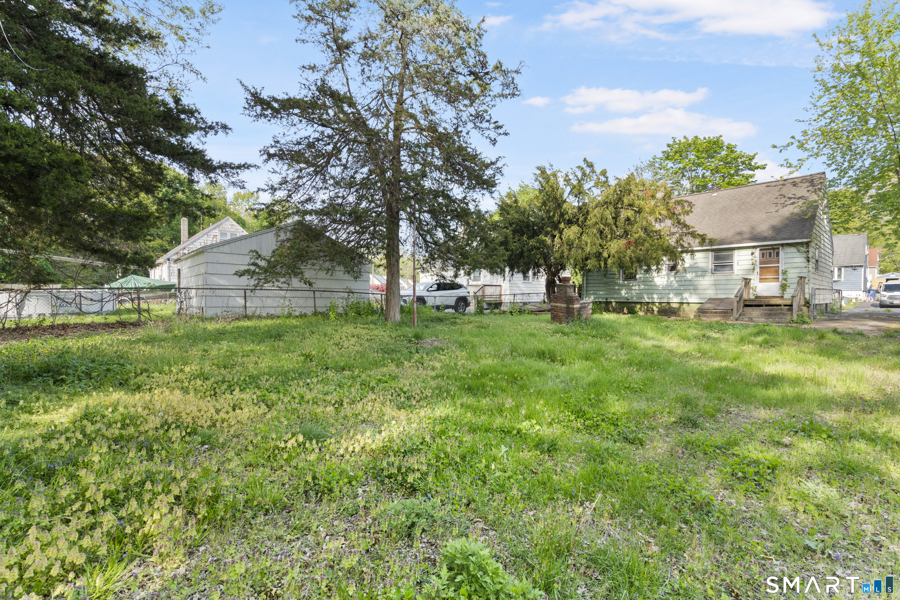 75 Brookside Avenue Bridgeport, CT 06606 - Photo 22 of 24 a view of a house with a yard