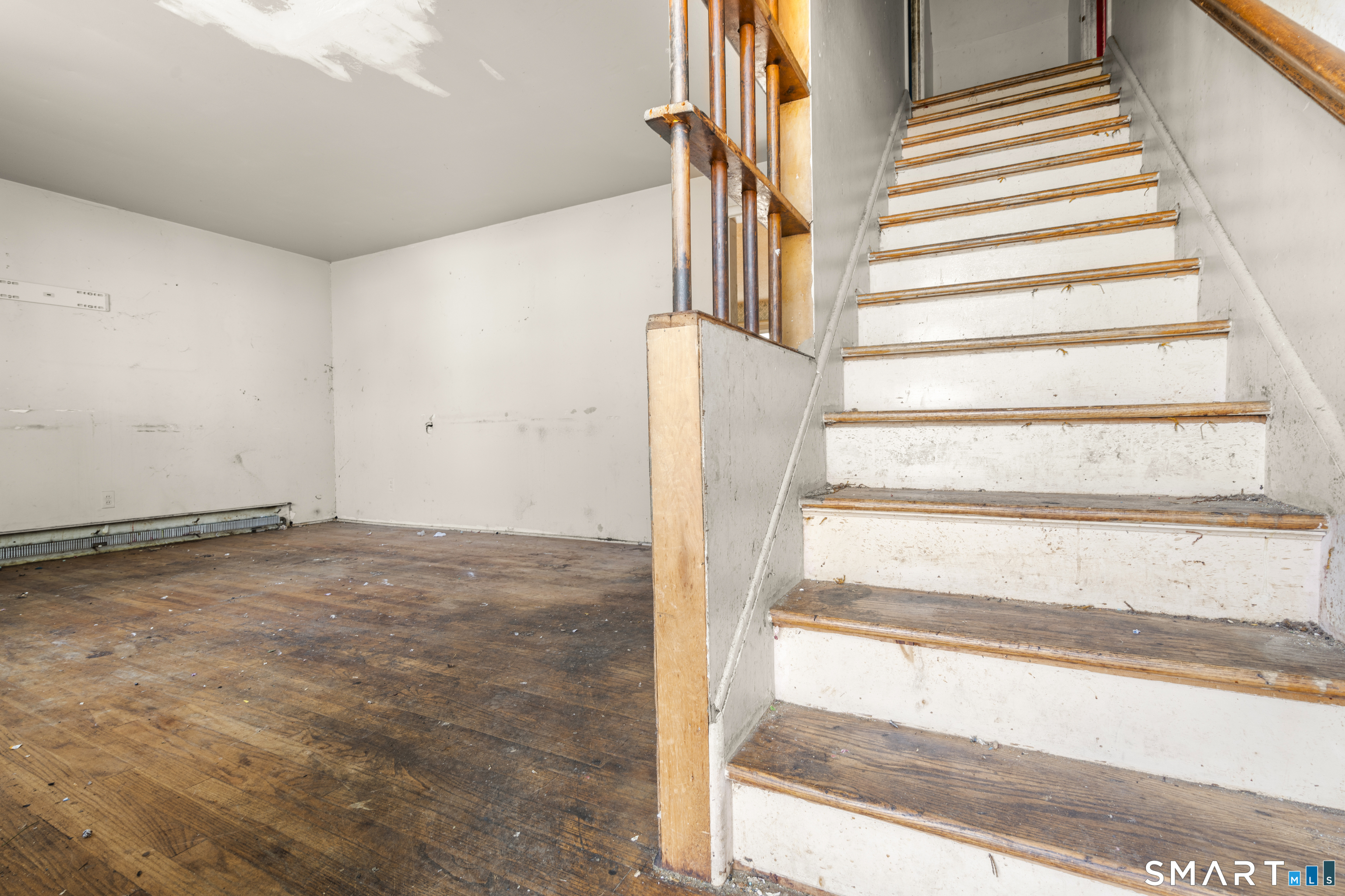 75 Brookside Avenue Bridgeport, CT 06606 - Photo 3 of 24 a view of staircase with white walls and a window