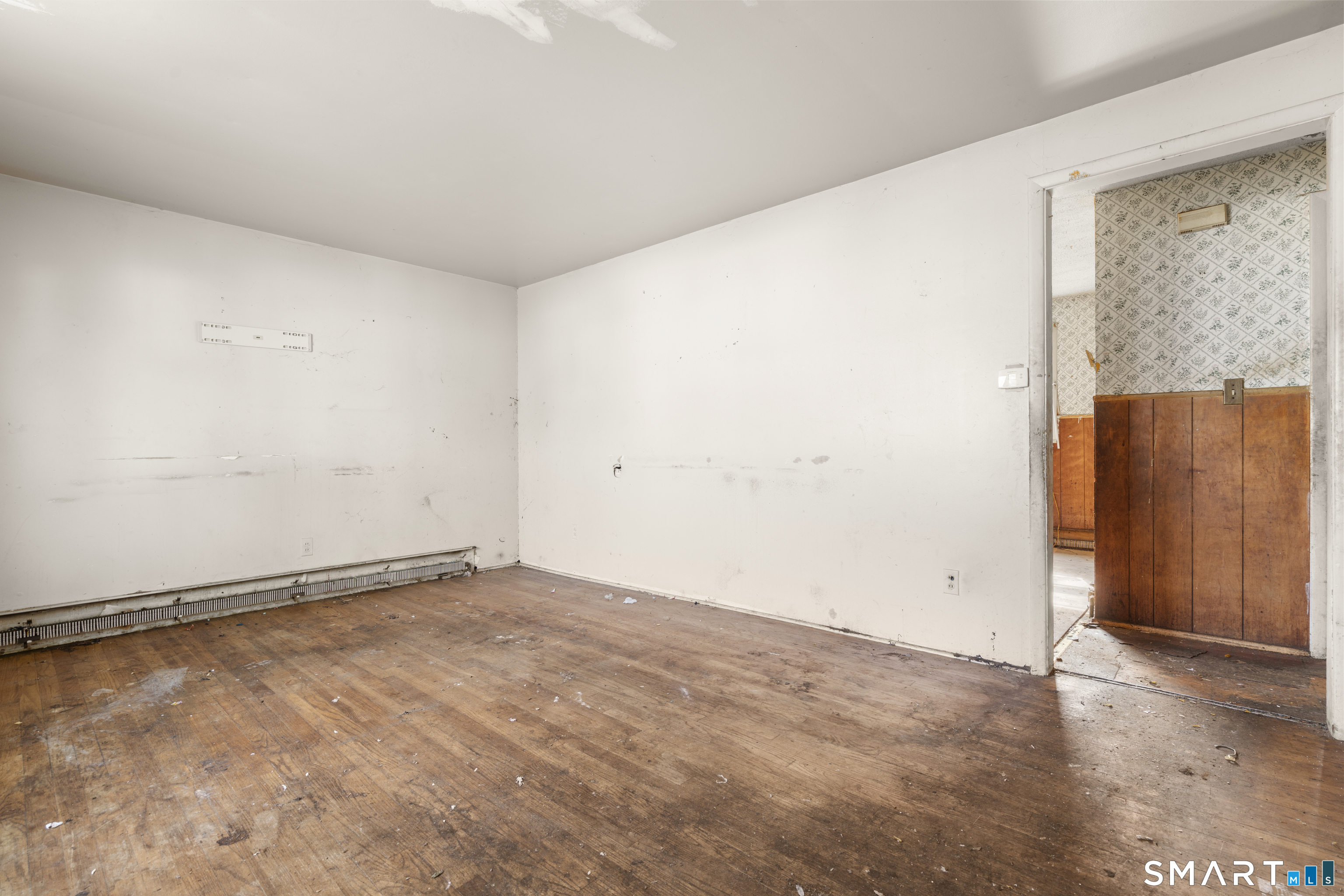 75 Brookside Avenue Bridgeport, CT 06606 - Photo 4 of 24 an empty room with wooden floor and windows