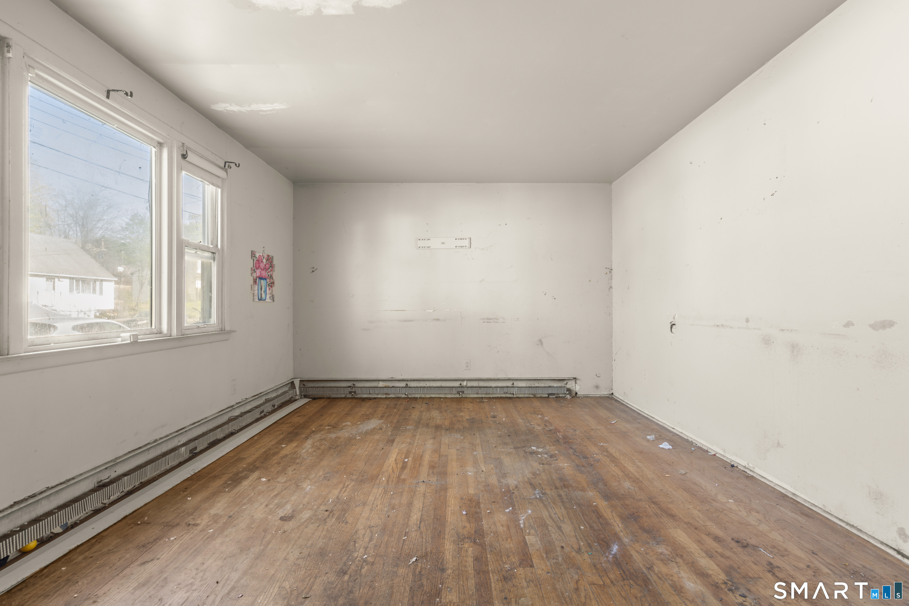 75 Brookside Avenue Bridgeport, CT 06606 - Photo 5 of 24 a view of a room with wooden floor and window