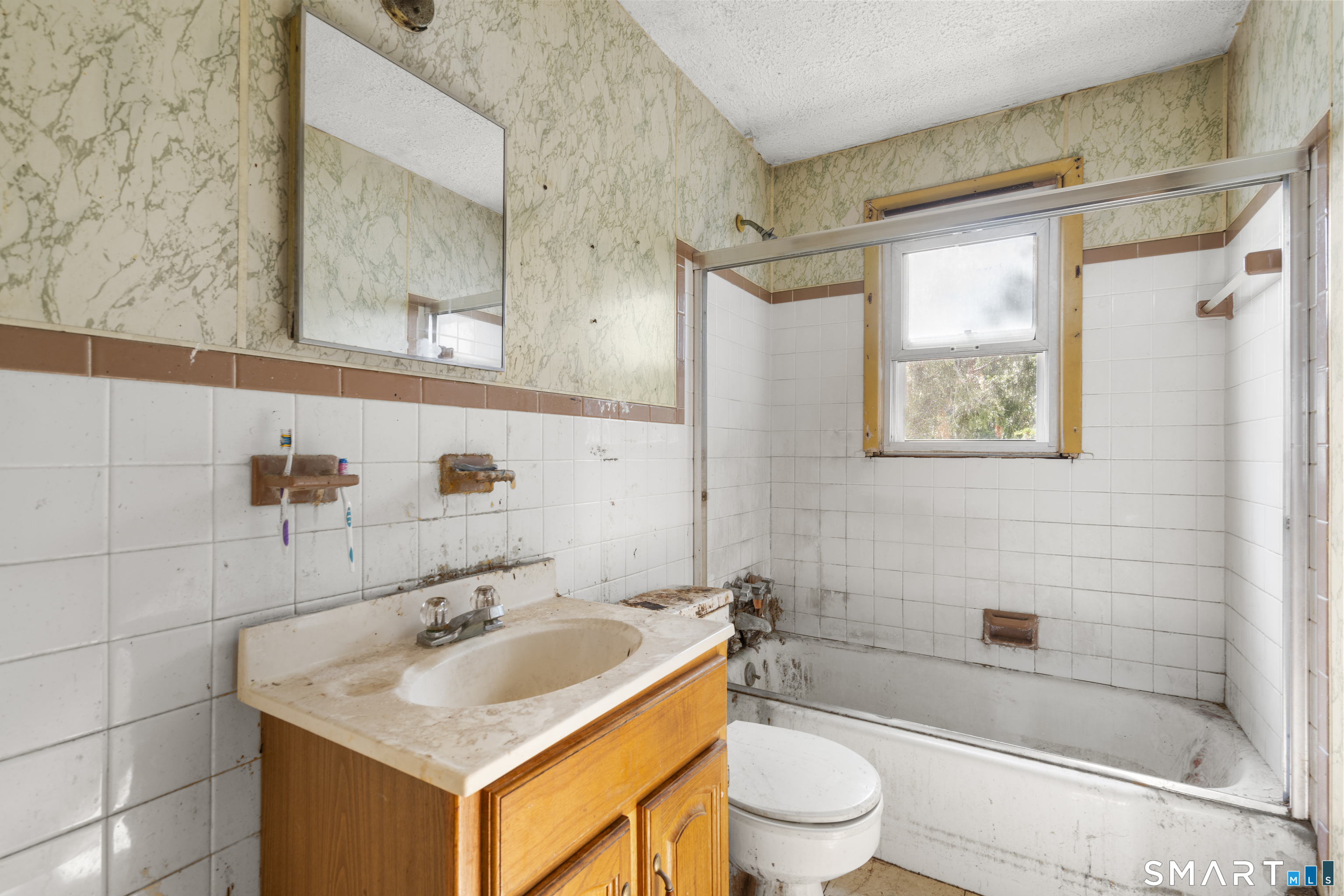 75 Brookside Avenue Bridgeport, CT 06606 - Photo 10 of 24 a bathroom with a sink toilet and shower
