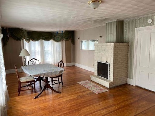 15 Varney Street Lowell, MA 01854 - Photo 11 of 32 a living room with furniture a fireplace and a table