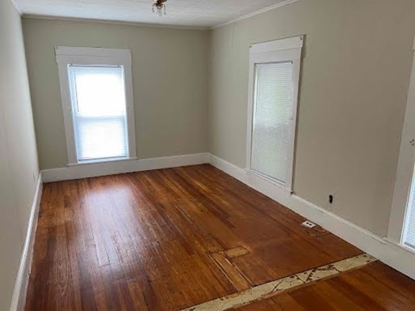 15 Varney Street Lowell, MA 01854 - Photo 12 of 32 an empty room with wooden floor and windows