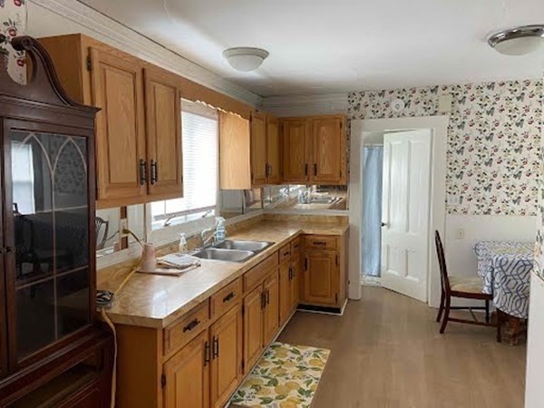 15 Varney Street Lowell, MA 01854 - Photo 13 of 32 a kitchen with a sink stove and wooden cabinets