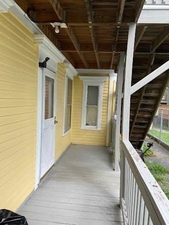 15 Varney Street Lowell, MA 01854 - Photo 17 of 32 a view of a porch with wooden floor and stairs