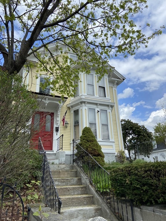 15 Varney Street Lowell, MA 01854 - Photo 2 of 32 a front view of a house with garden