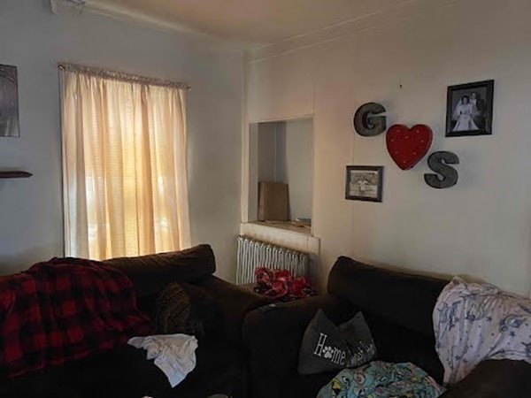 15 Varney Street Lowell, MA 01854 - Photo 22 of 32 a living room with furniture and a window