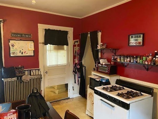 15 Varney Street Lowell, MA 01854 - Photo 26 of 32 a kitchen with stainless steel appliances a stove a refrigerator and a dining table