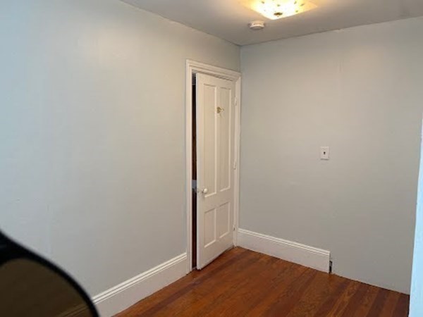 15 Varney Street Lowell, MA 01854 - Photo 8 of 32 an empty room with wooden floor and closet