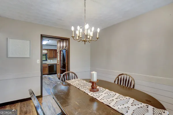 a view of a dining room with furniture and chandelier