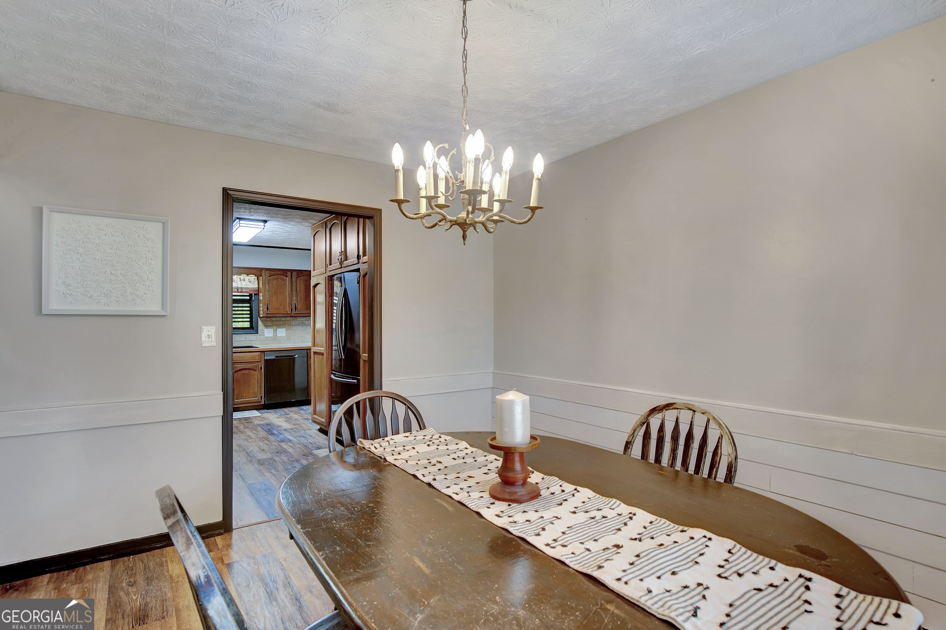 1188 Raymond Hill Road Newnan, GA 30265 - Photo 11 of 47 a view of a dining room with furniture and chandelier
