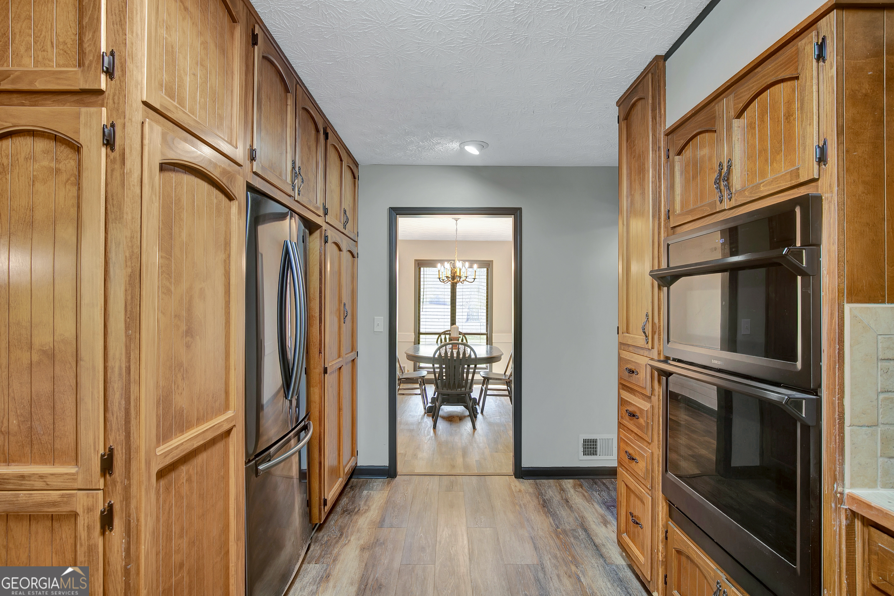 1188 Raymond Hill Road Newnan, GA 30265 - Photo 12 of 47 a view of a hallway with wooden floor and staircase