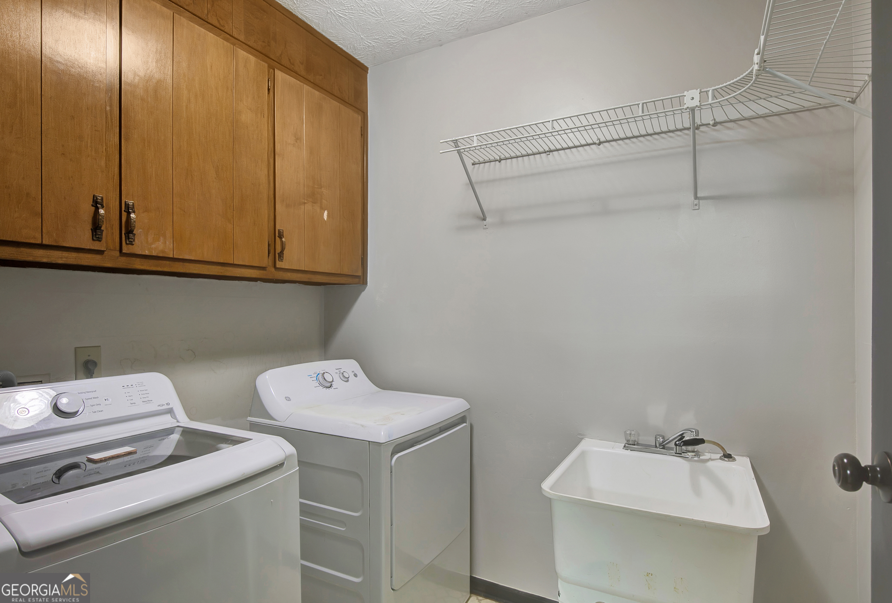 1188 Raymond Hill Road Newnan, GA 30265 - Photo 17 of 47 a utility room with dryer and washer