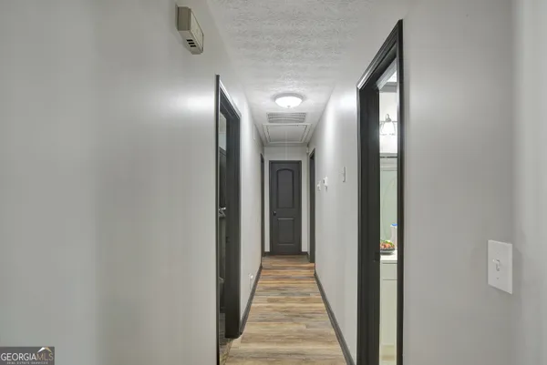 a view of a hallway with wooden floor