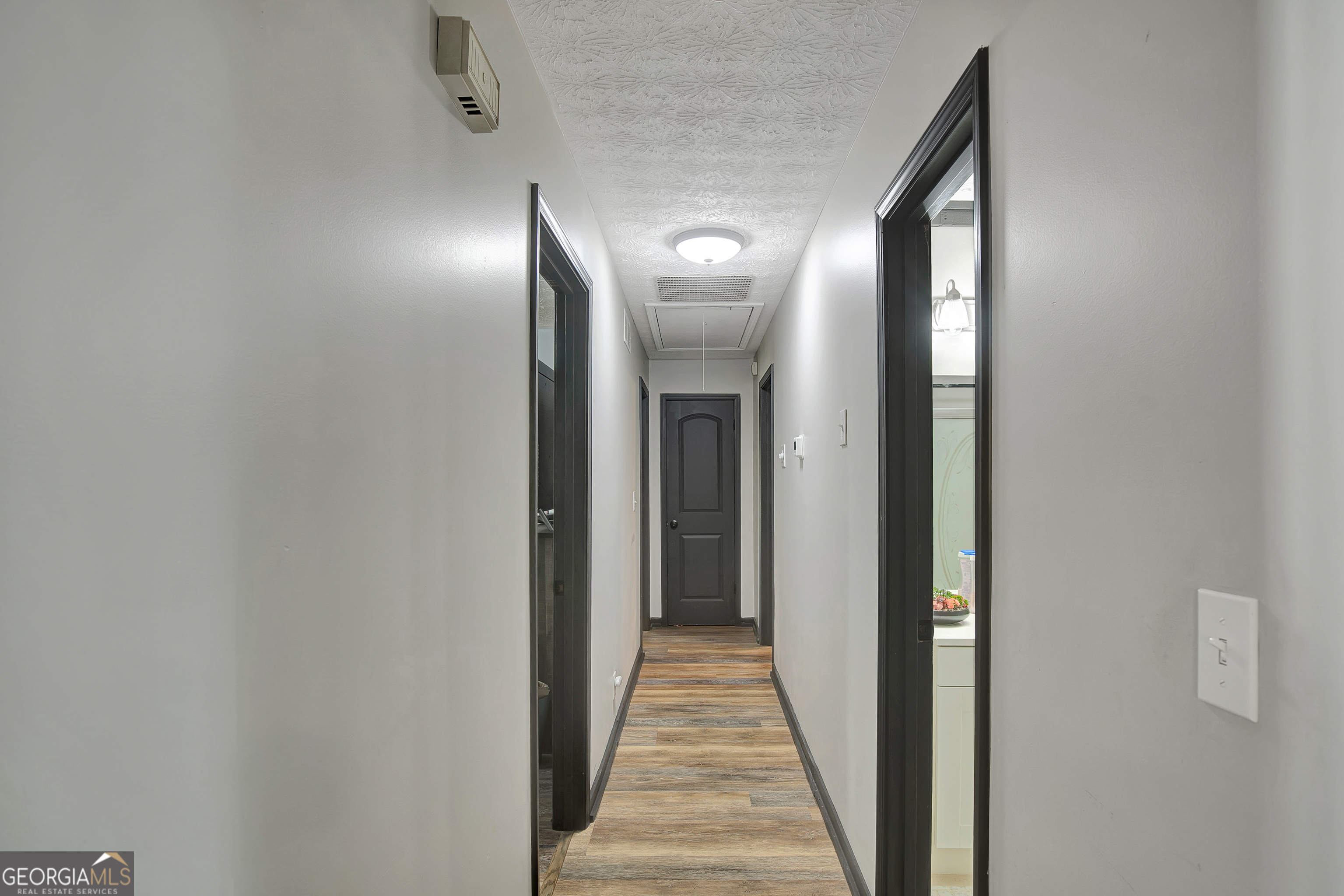 1188 Raymond Hill Road Newnan, GA 30265 - Photo 18 of 47 a view of a hallway with wooden floor