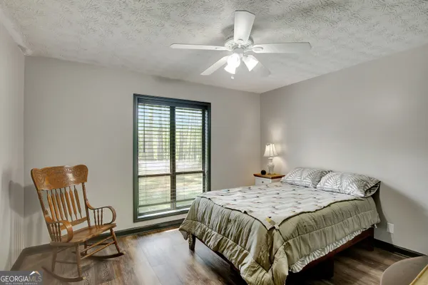 a bedroom that has a bed and a chair in it