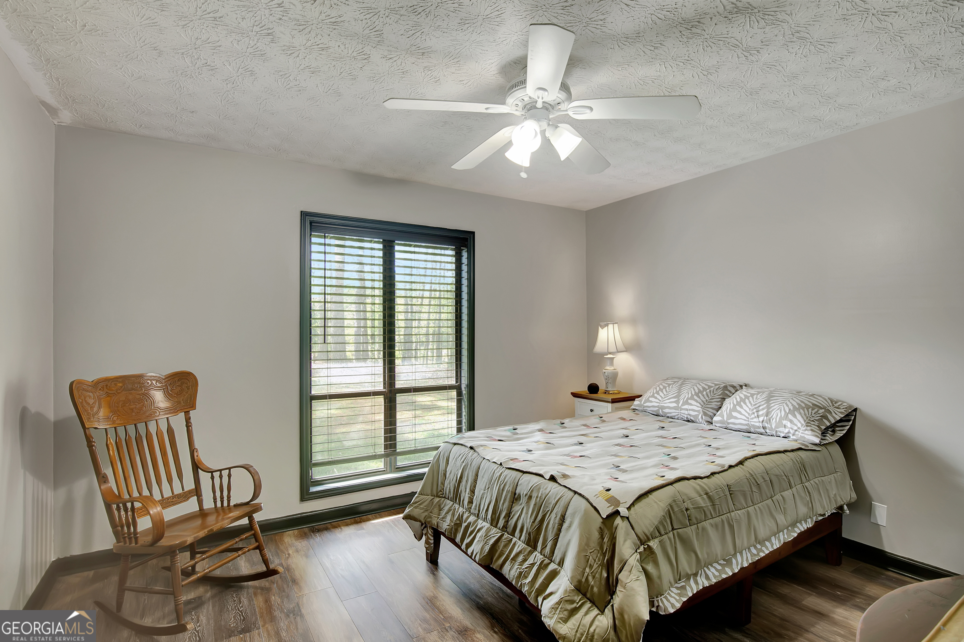 1188 Raymond Hill Road Newnan, GA 30265 - Photo 20 of 47 a bedroom that has a bed and a chair in it