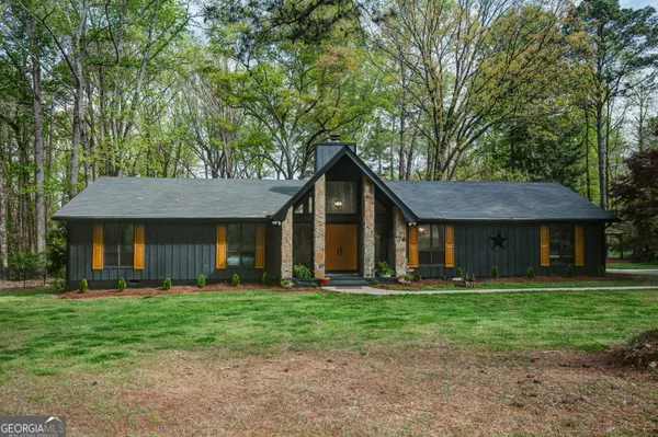 a front view of house with yard and green space