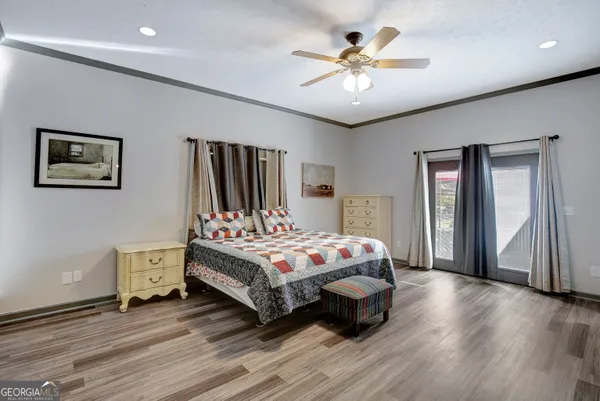a bedroom with a bed and a chandelier