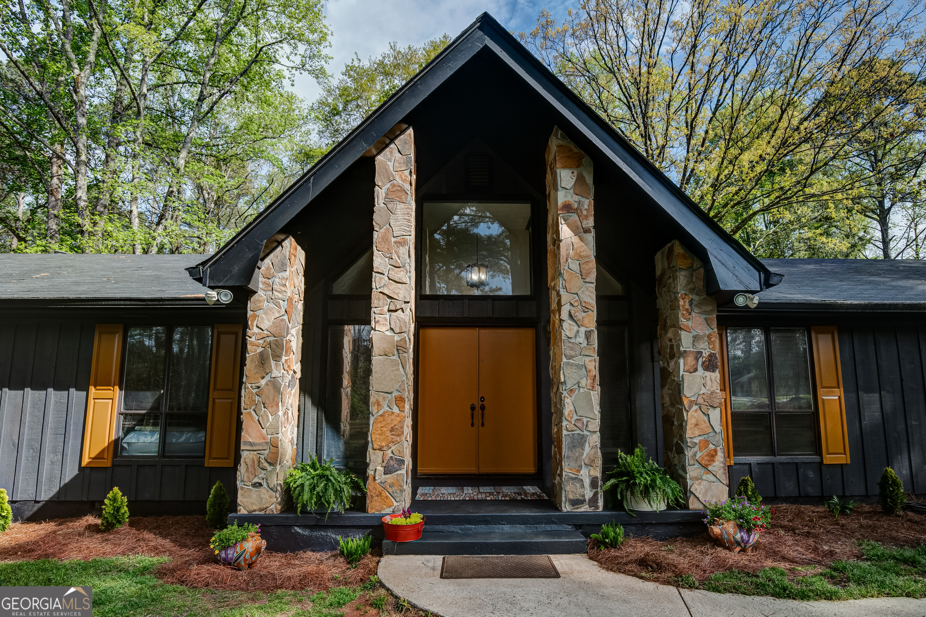 1188 Raymond Hill Road Newnan, GA 30265 - Photo 3 of 47 a front view of a house with garden