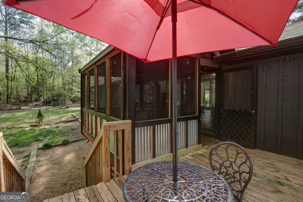 a backyard of a house with table and chairs