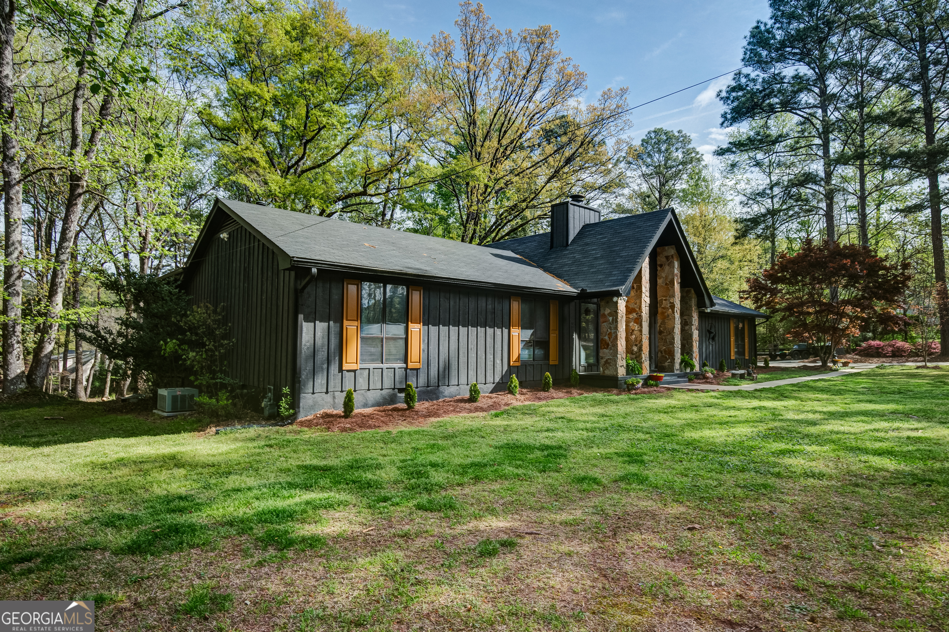 1188 Raymond Hill Road Newnan, GA 30265 - Photo 4 of 47 a front view of a house with a yard