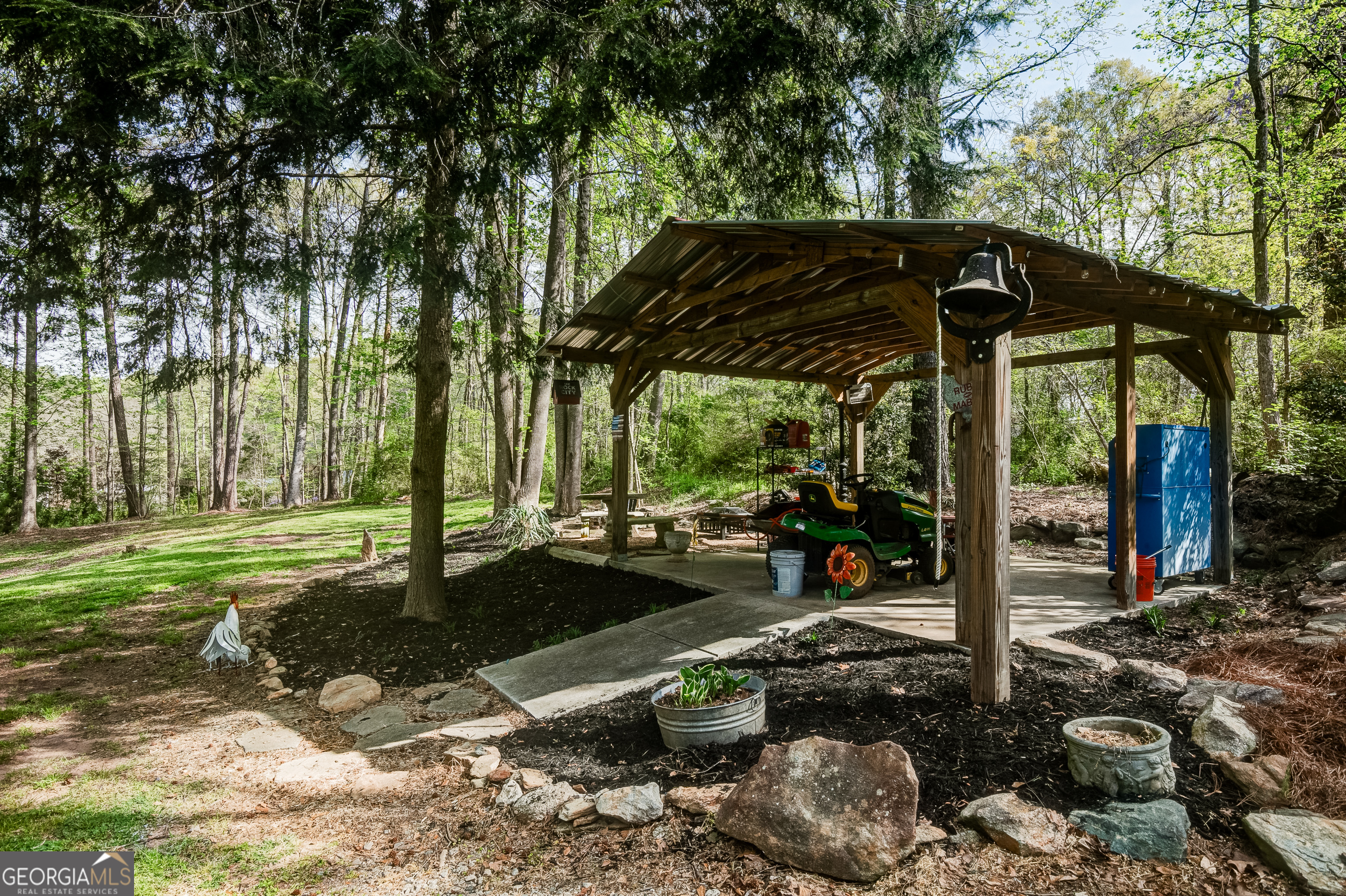 1188 Raymond Hill Road Newnan, GA 30265 - Photo 44 of 47 a view of a patio with table and chairs under an umbrella