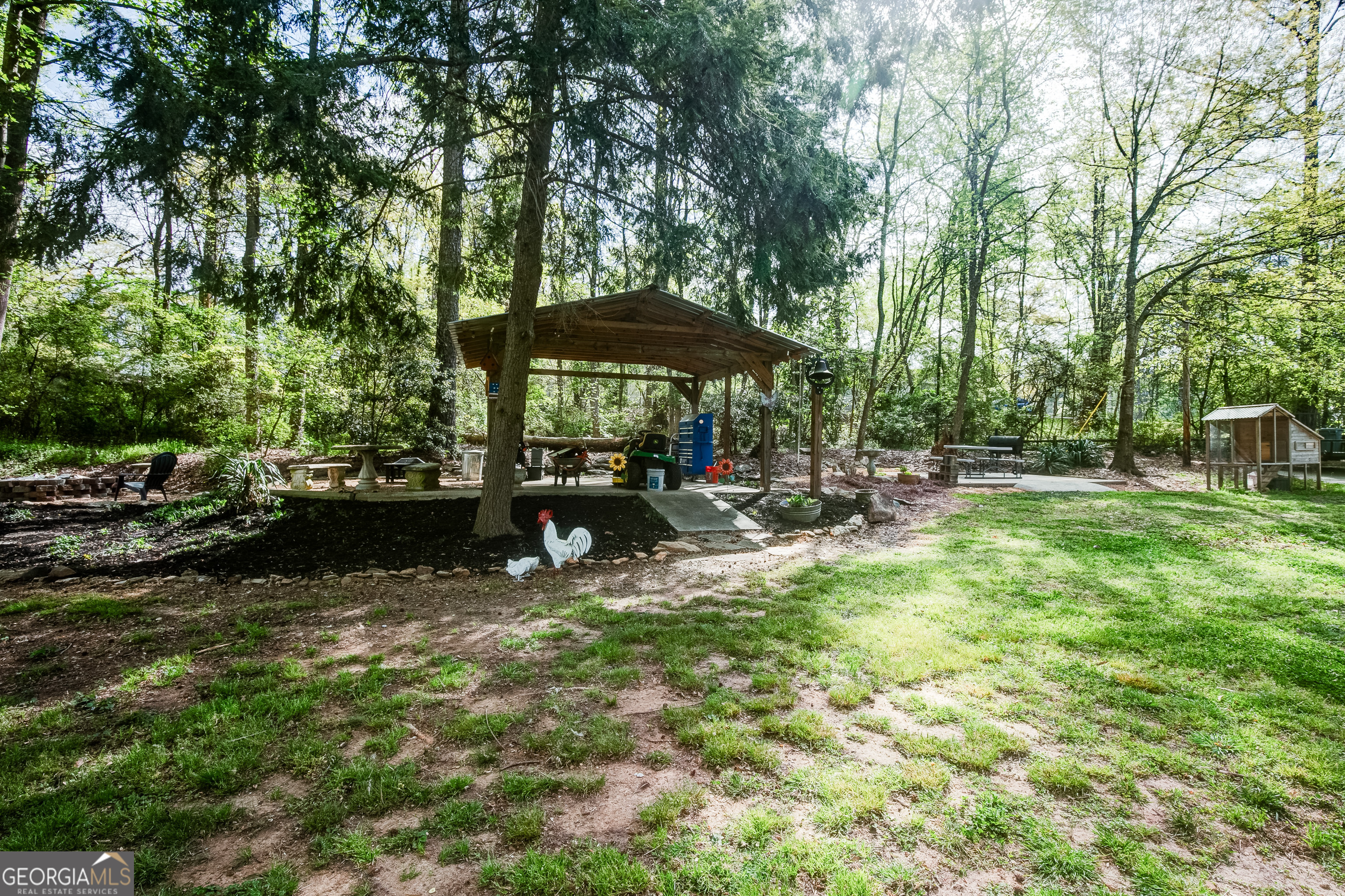 1188 Raymond Hill Road Newnan, GA 30265 - Photo 45 of 47 a view of a chair and table on the garden