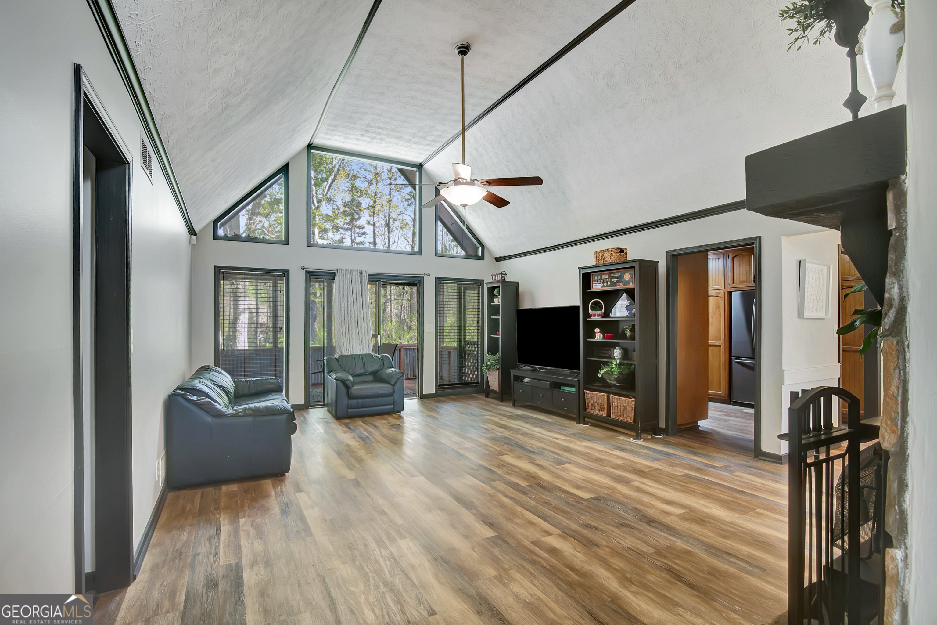 1188 Raymond Hill Road Newnan, GA 30265 - Photo 6 of 47 a view of a livingroom with furniture a flat screen tv