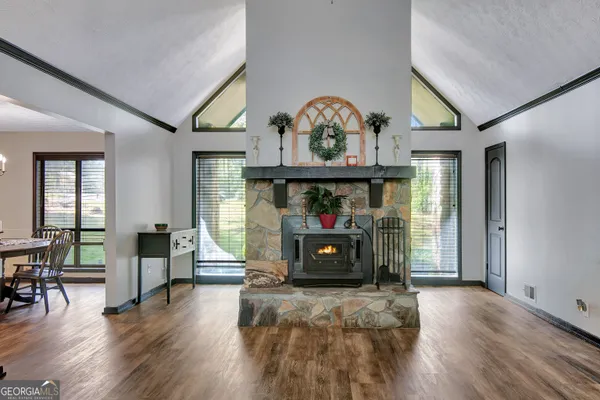 a view of a livingroom with wooden floor and furniture