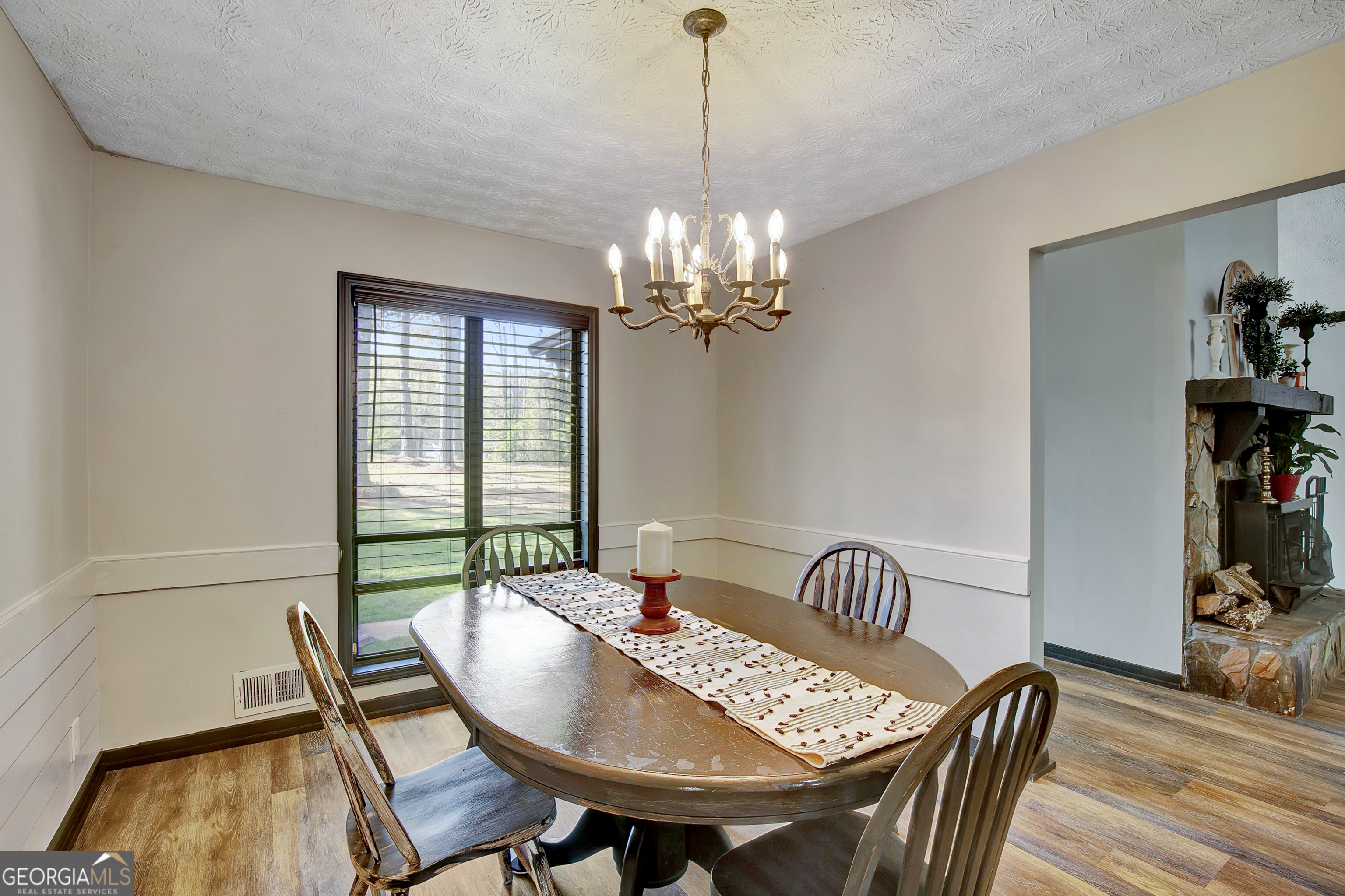 1188 Raymond Hill Road Newnan, GA 30265 - Photo 10 of 47 a view of a dining room with furniture wooden floor and a chandelier