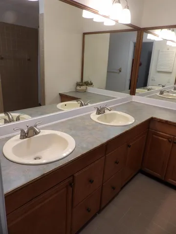 a bathroom with a double vanity sink and a mirror
