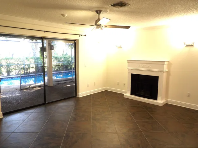 a view of an empty room with a fireplace