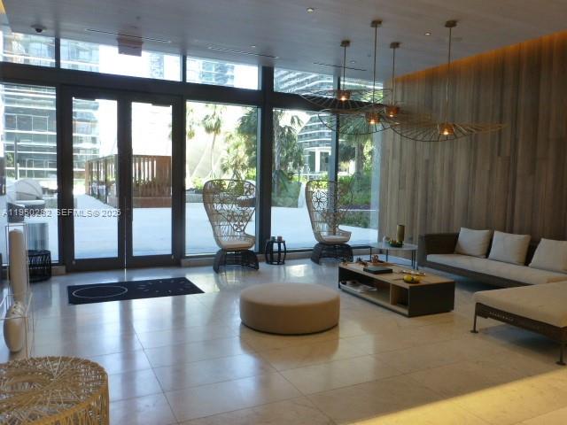 88 Southwest 7th Street, Unit 2203 Miami, FL 33130 - Photo 24 of 37 a living room with furniture and floor to ceiling windows